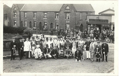 Joshua Biltcliffe’s store at 6 Bridge Street, Penistone with celebrations at the end of WW1.  The family houses are to the left and the studio was at the rear of the shop