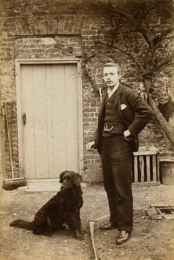 J H Wilson with his dog behind the shop at Weaverthorpe - about 1897