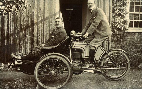 J H Wilson on his Rex tricar (new model) with Mr. T Sanderson in the front – about 1905